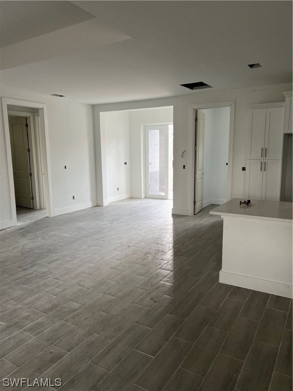 335 Ranch Avenue Lehigh Acres, FL 33974 - Photo 11 of 24 a view of an empty room with wooden floor and cabinet