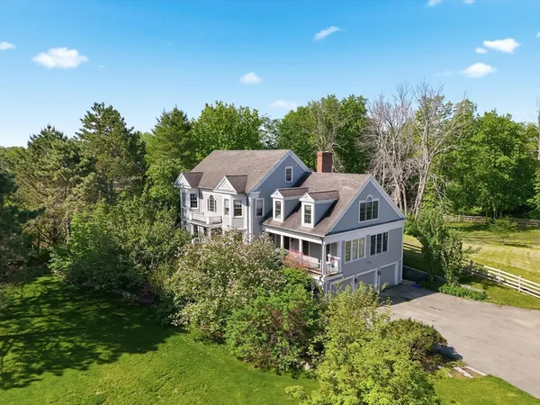 a aerial view of a house with a yard and plants