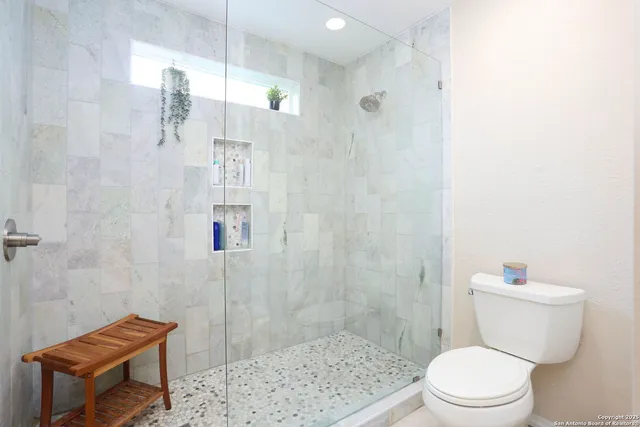 a white toilet sitting next to a bathroom sink
