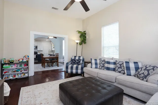 a living room with furniture and wooden floor