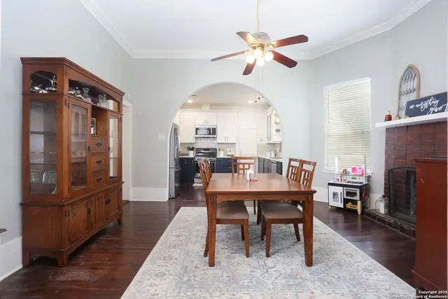 a view of a dining room with furniture a chandelier and wooden floor