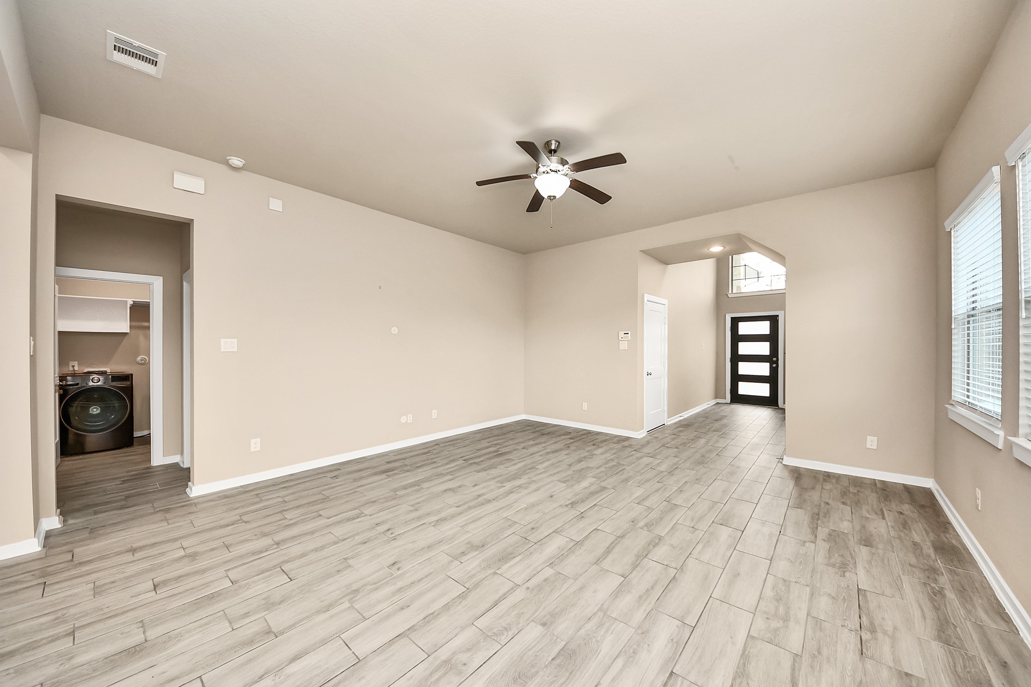 6030 Rivercane Way Katy, TX 77493 - Photo 12 of 41 wooden floor in an empty room with a window