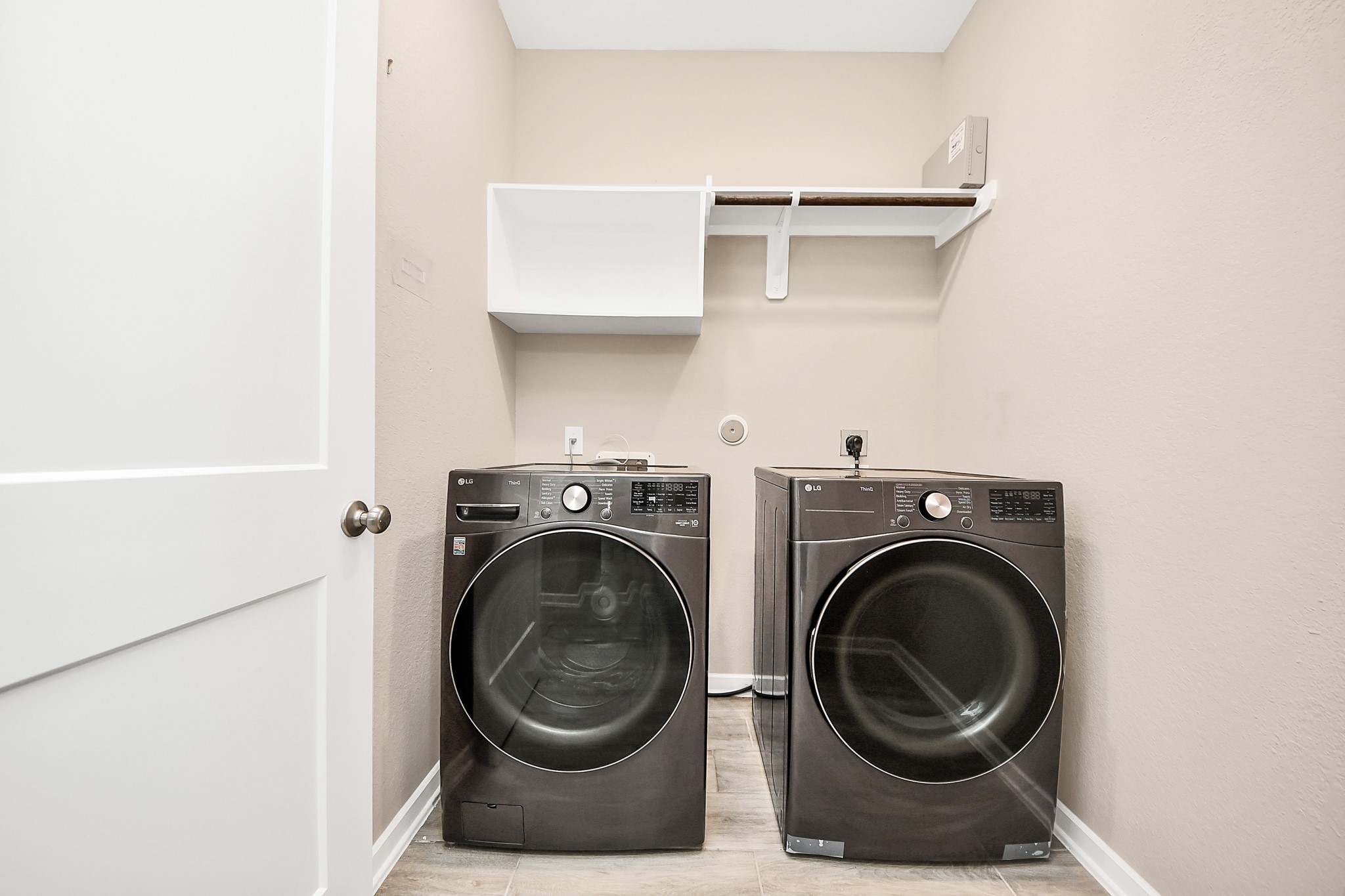 6030 Rivercane Way Katy, TX 77493 - Photo 13 of 41 Spacious utility room featuring extra overhead shelving and a hanging rack; washer and dryer included.