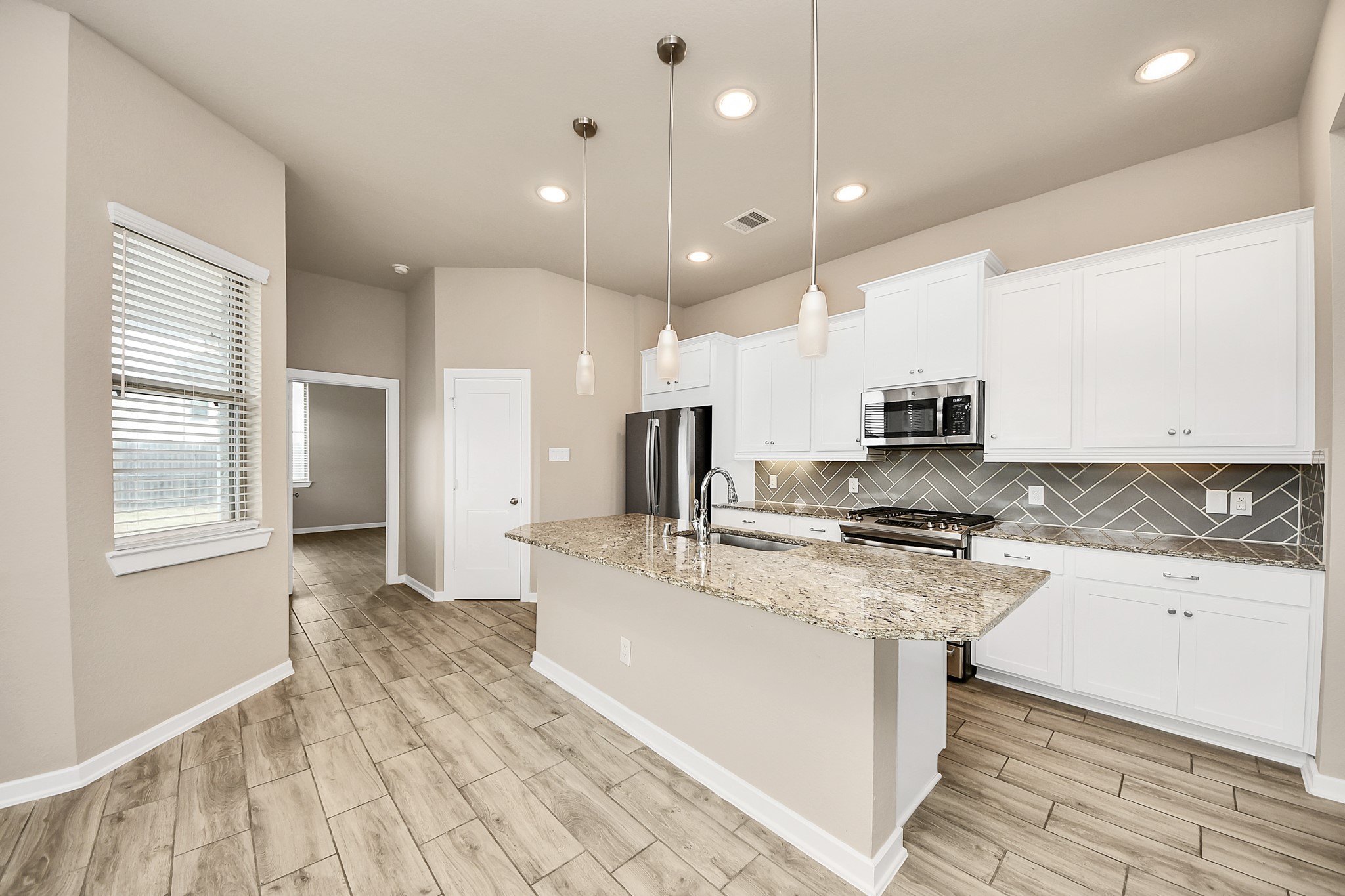 6030 Rivercane Way Katy, TX 77493 - Photo 14 of 41 a large kitchen with stainless steel appliances granite countertop a stove a sink and a refrigerator