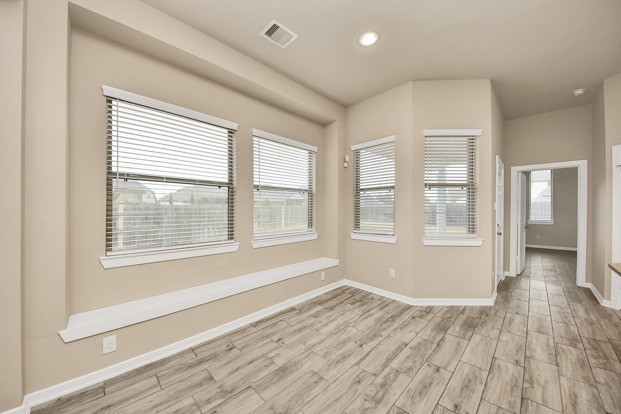 6030 Rivercane Way Katy, TX 77493 - Photo 17 of 41 a view of an empty room with wooden floor and a window