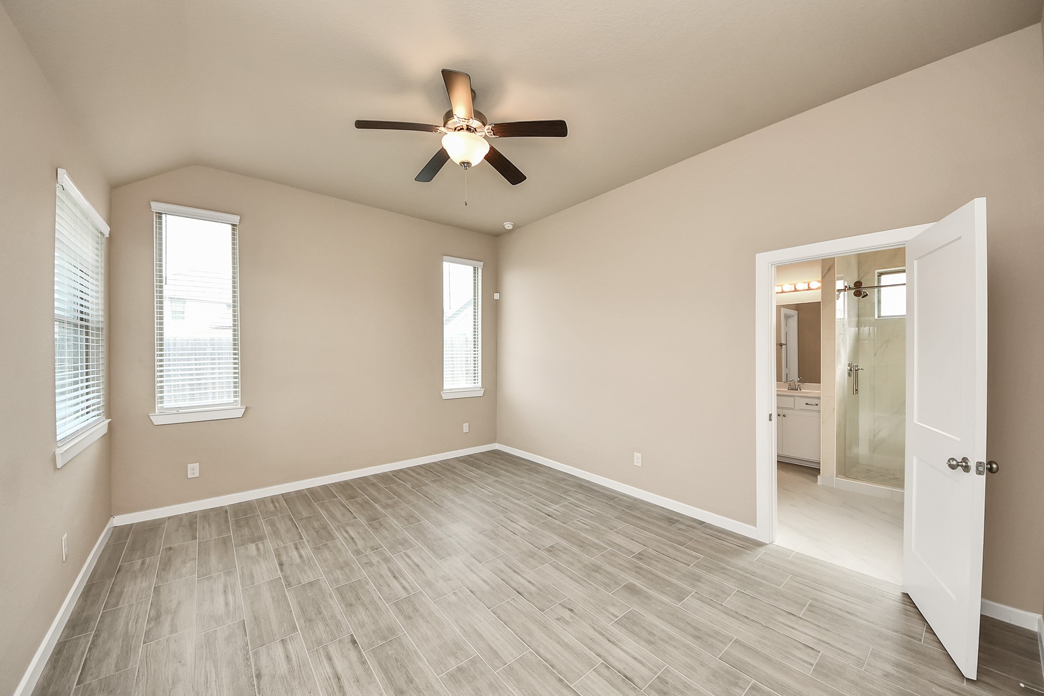 6030 Rivercane Way Katy, TX 77493 - Photo 22 of 41 a view of an empty room with wooden floor and a window