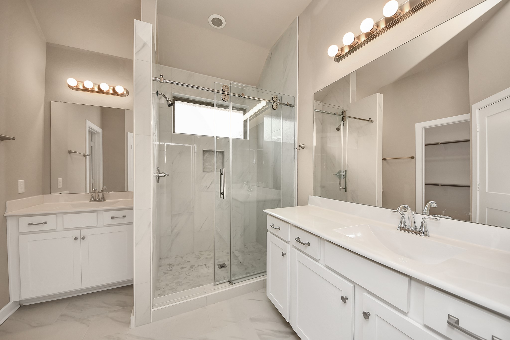 6030 Rivercane Way Katy, TX 77493 - Photo 23 of 41 Primary bathroom offers dual vanities—no fighting for space here—along with a walk-in tile shower and glass enclosure.