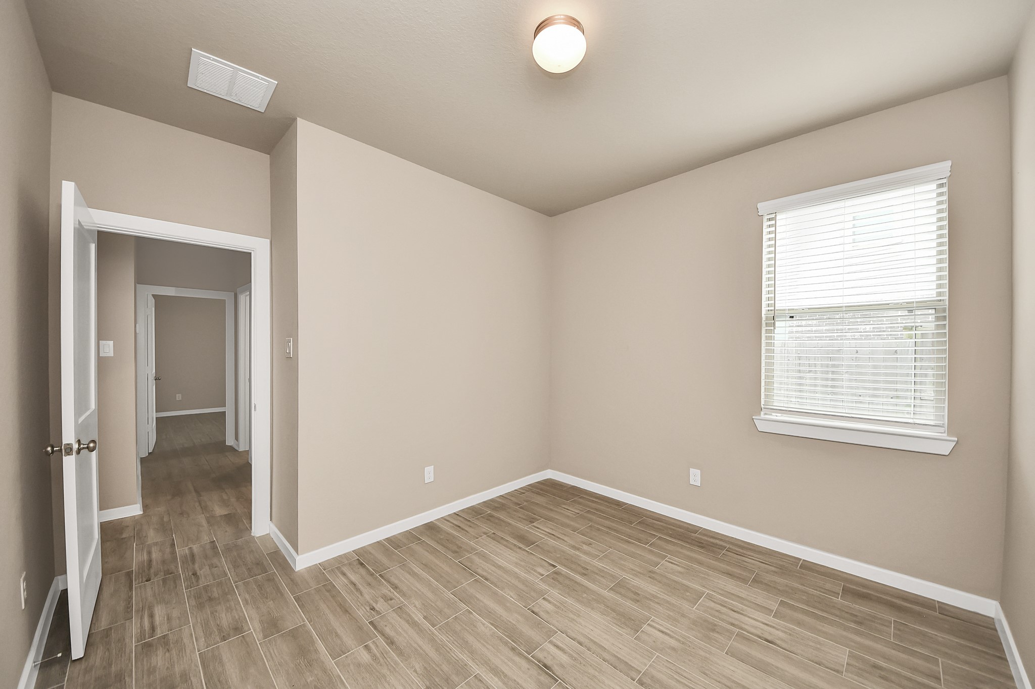 6030 Rivercane Way Katy, TX 77493 - Photo 28 of 41 A hallway view from the secondary bedroom leading into the third bedroom, secondary full bathroom, and utility room.
