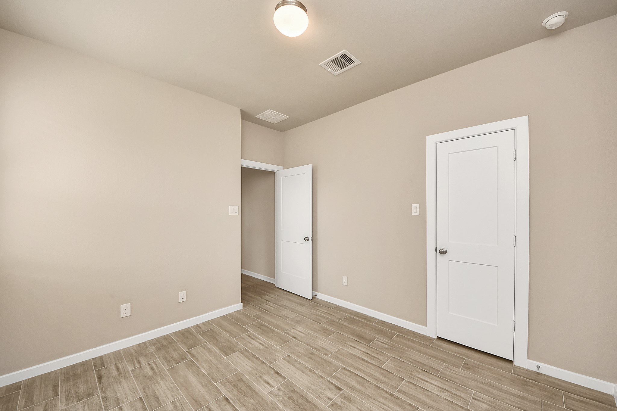 6030 Rivercane Way Katy, TX 77493 - Photo 31 of 41 an empty room with wooden floor and windows