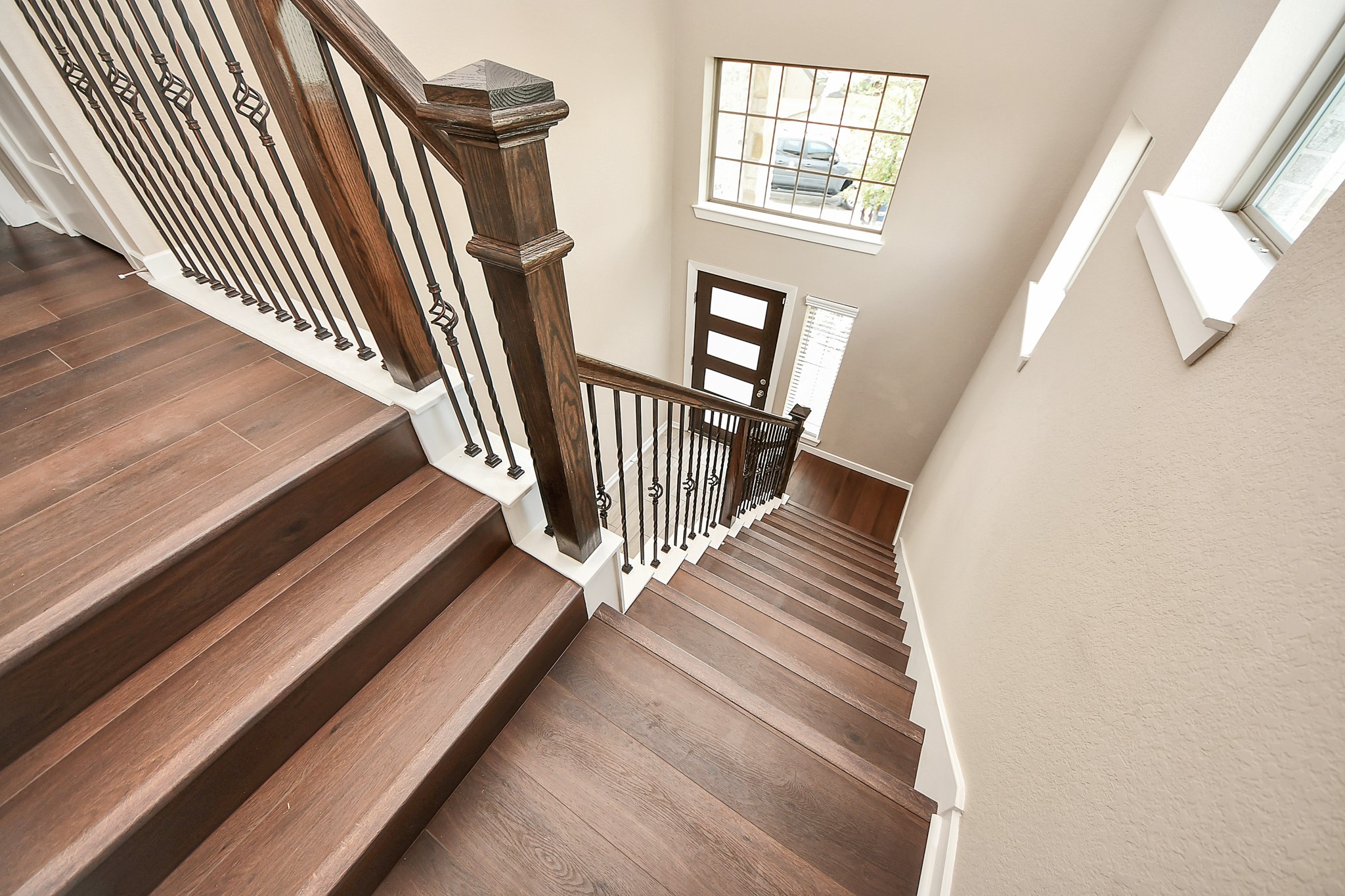 6030 Rivercane Way Katy, TX 77493 - Photo 32 of 41 A view of the entrance from the second floor. LV flooring on the staircase and fourth bedroom.