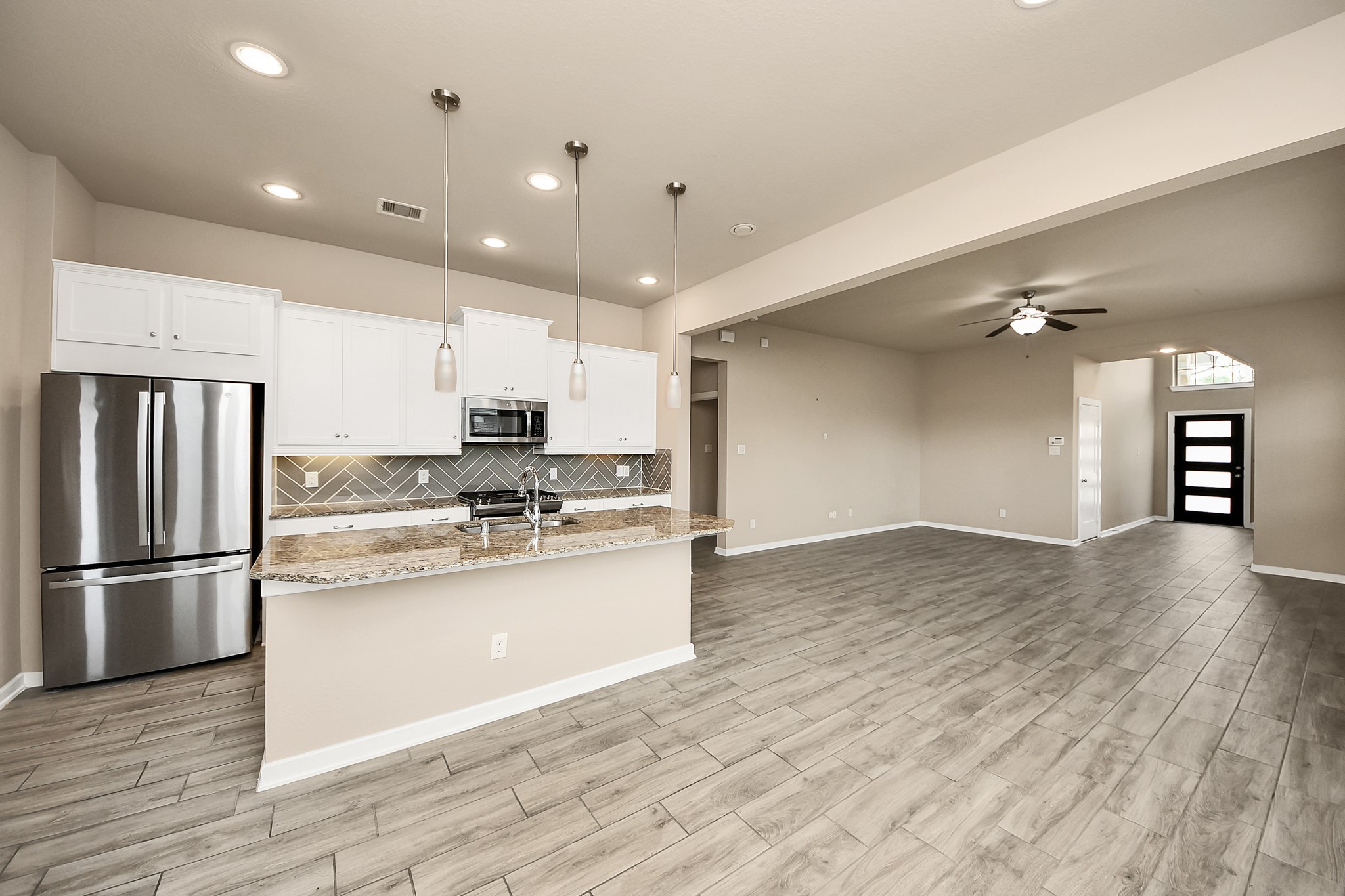 6030 Rivercane Way Katy, TX 77493 - Photo 5 of 41 a kitchen with stainless steel appliances granite countertop a refrigerator and a stove top oven