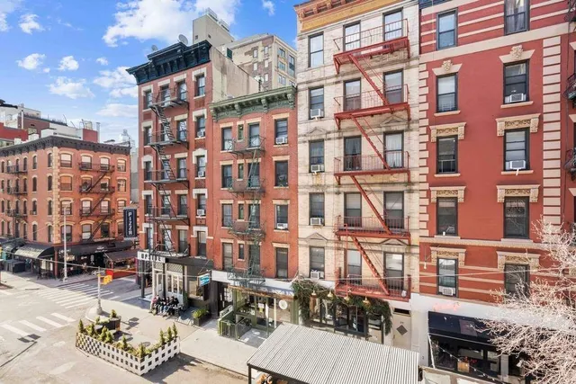 a front view of a house with plants