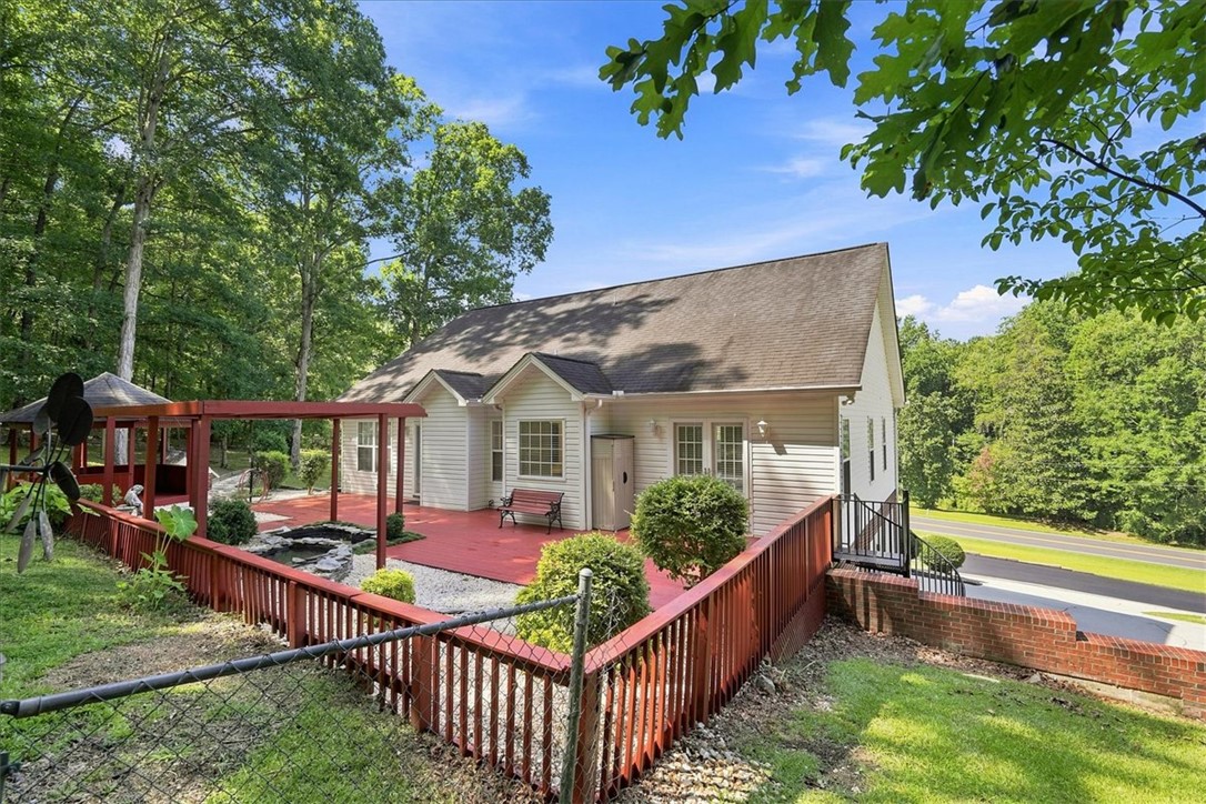 1052 Madden Bridge Road Central, SC 29630 - Photo 44 of 50 An expansive rear deck overlooks a private backyard surrounded by mature trees.