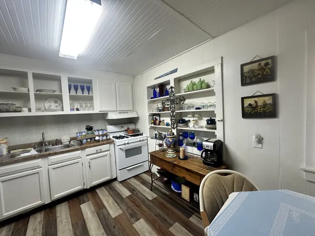 a kitchen with stainless steel appliances granite countertop a stove and cabinets