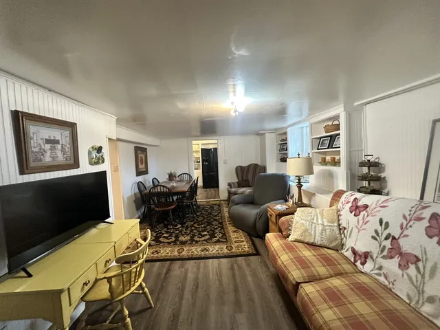 a living room with furniture fireplace and a flat screen tv