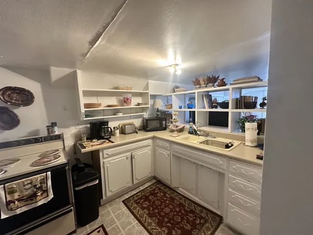 a kitchen with a sink stove and cabinets