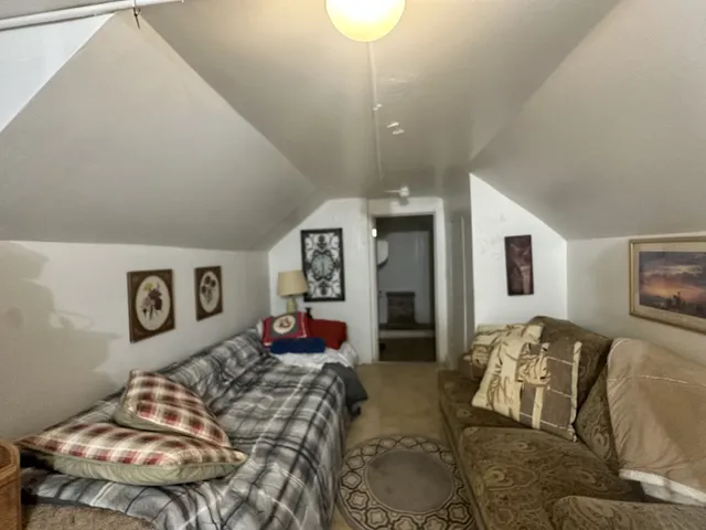 a bedroom with bed and wooden floor