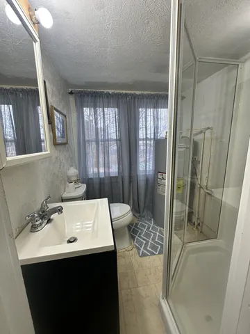 a bathroom with a sink a mirror and a shower