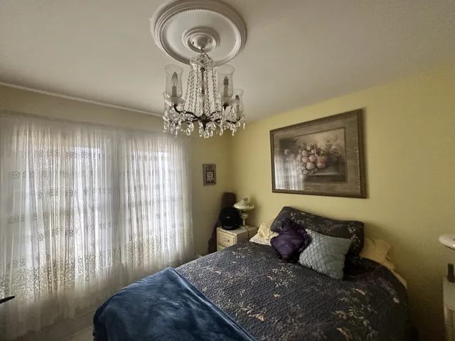 a large bed sitting in a bedroom next to a window
