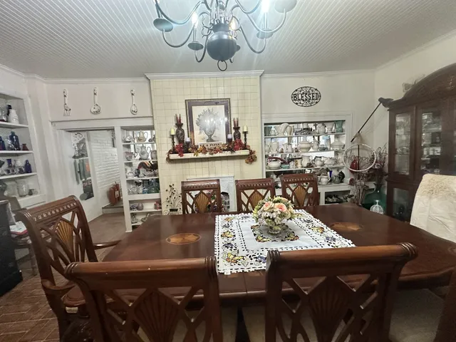 a view of a dining room with furniture a chandelier and wooden floor