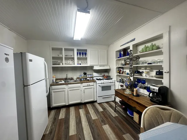 a kitchen with stainless steel appliances granite countertop a refrigerator stove top oven and sink