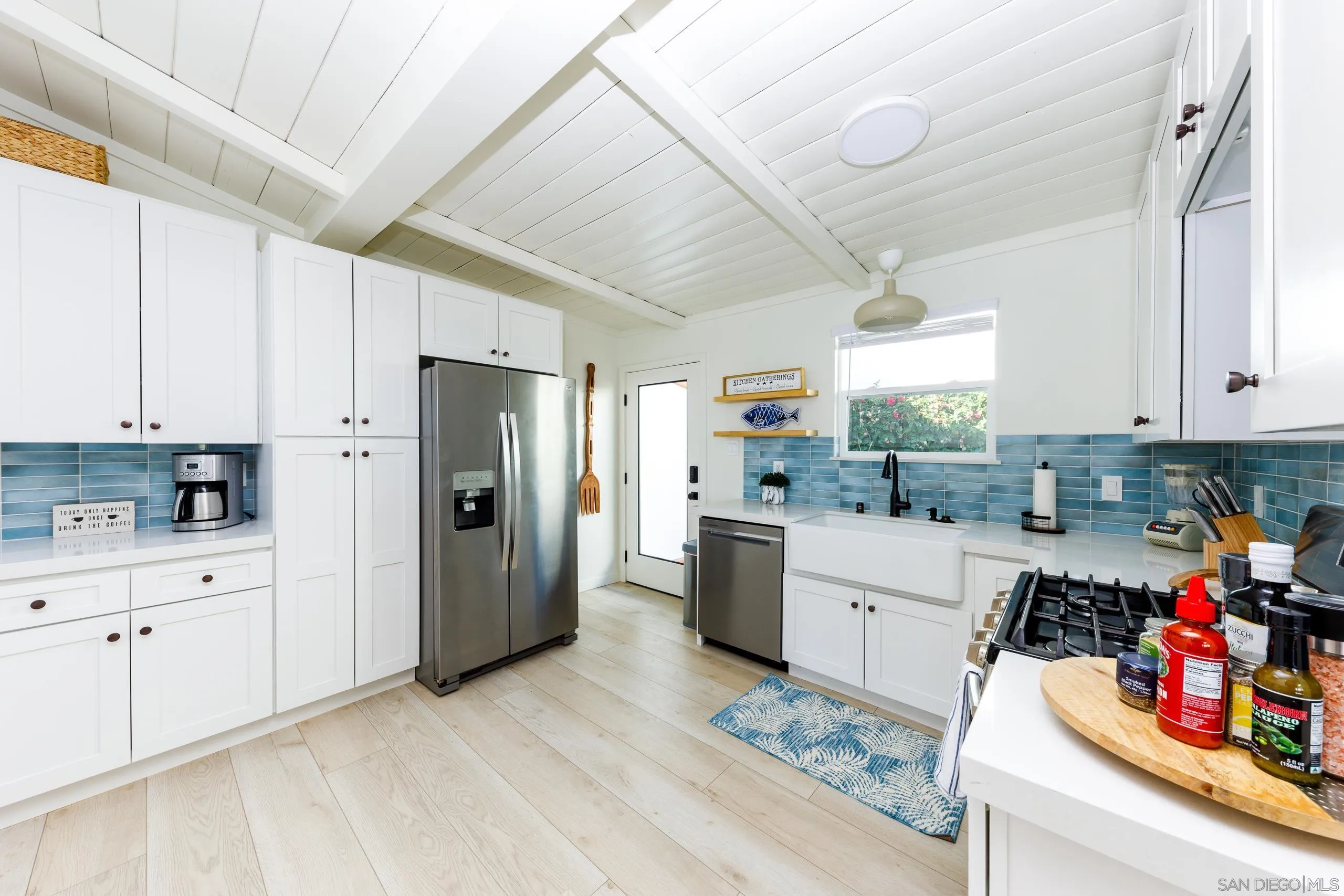 110 8th Street Del Mar, CA 92014 - Photo 11 of 45 a kitchen with a refrigerator and cabinets