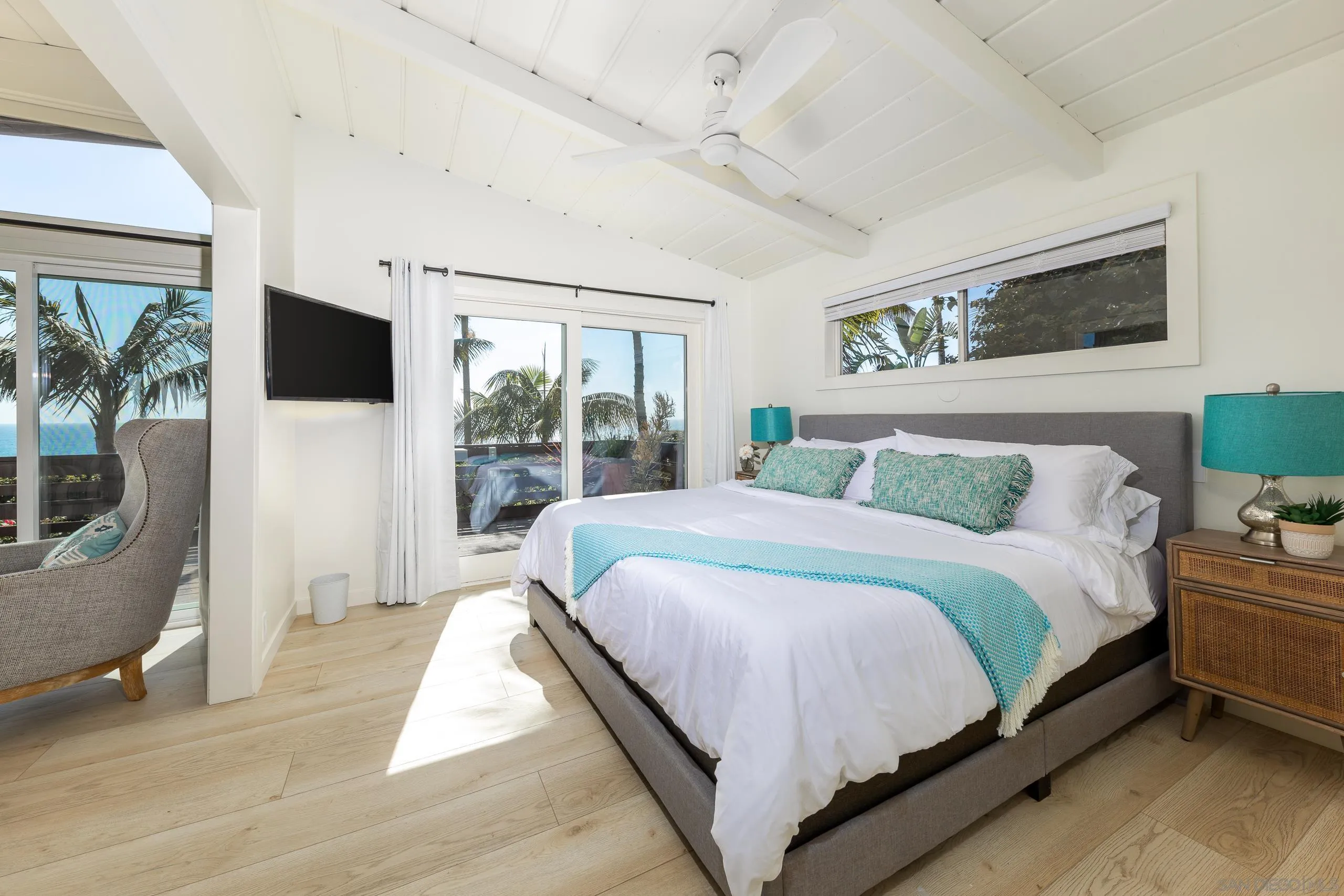 110 8th Street Del Mar, CA 92014 - Photo 16 of 45 a spacious bedroom with a large bed and a flat tv screen