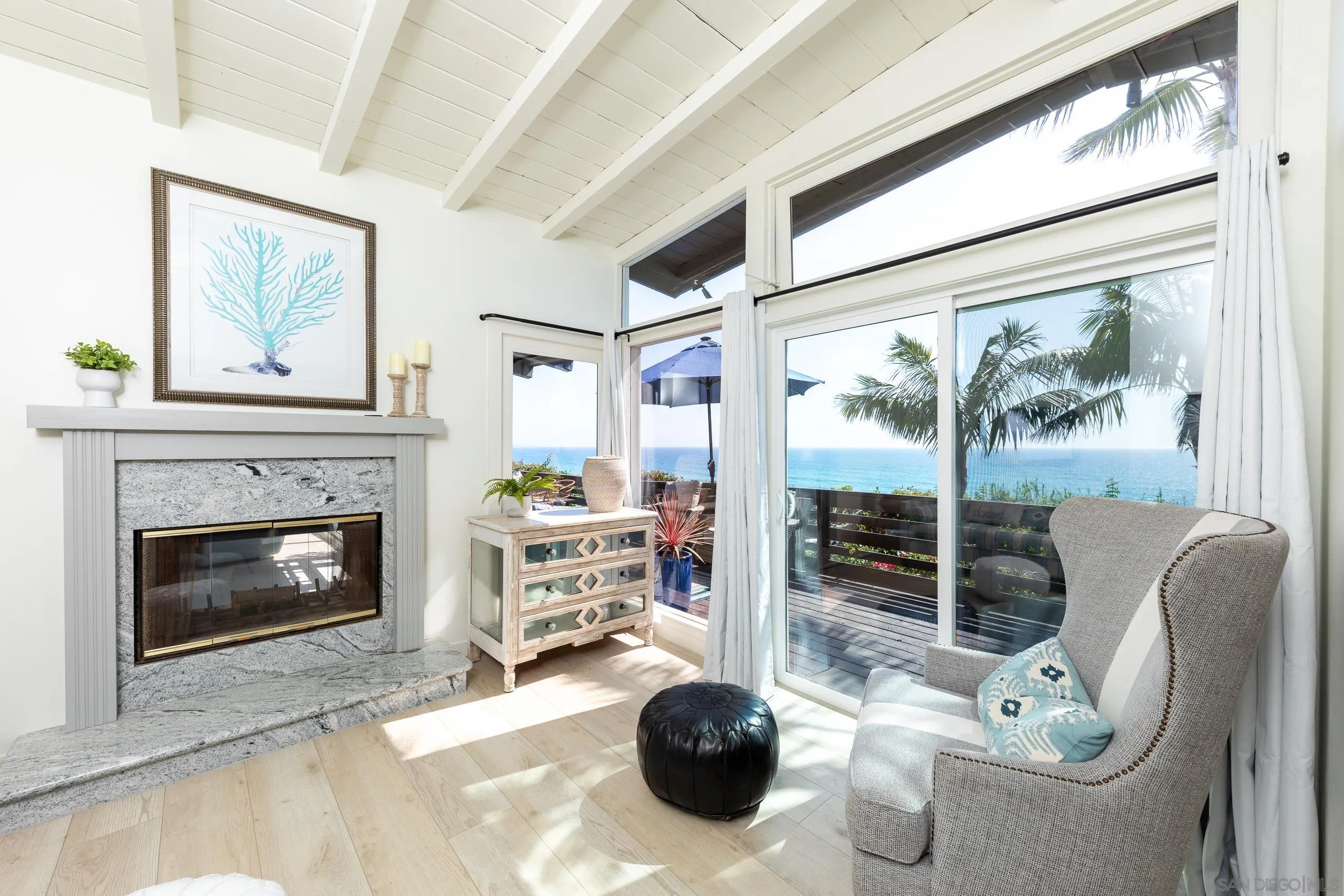 110 8th Street Del Mar, CA 92014 - Photo 17 of 45 a living room with furniture a fireplace and a floor to ceiling window