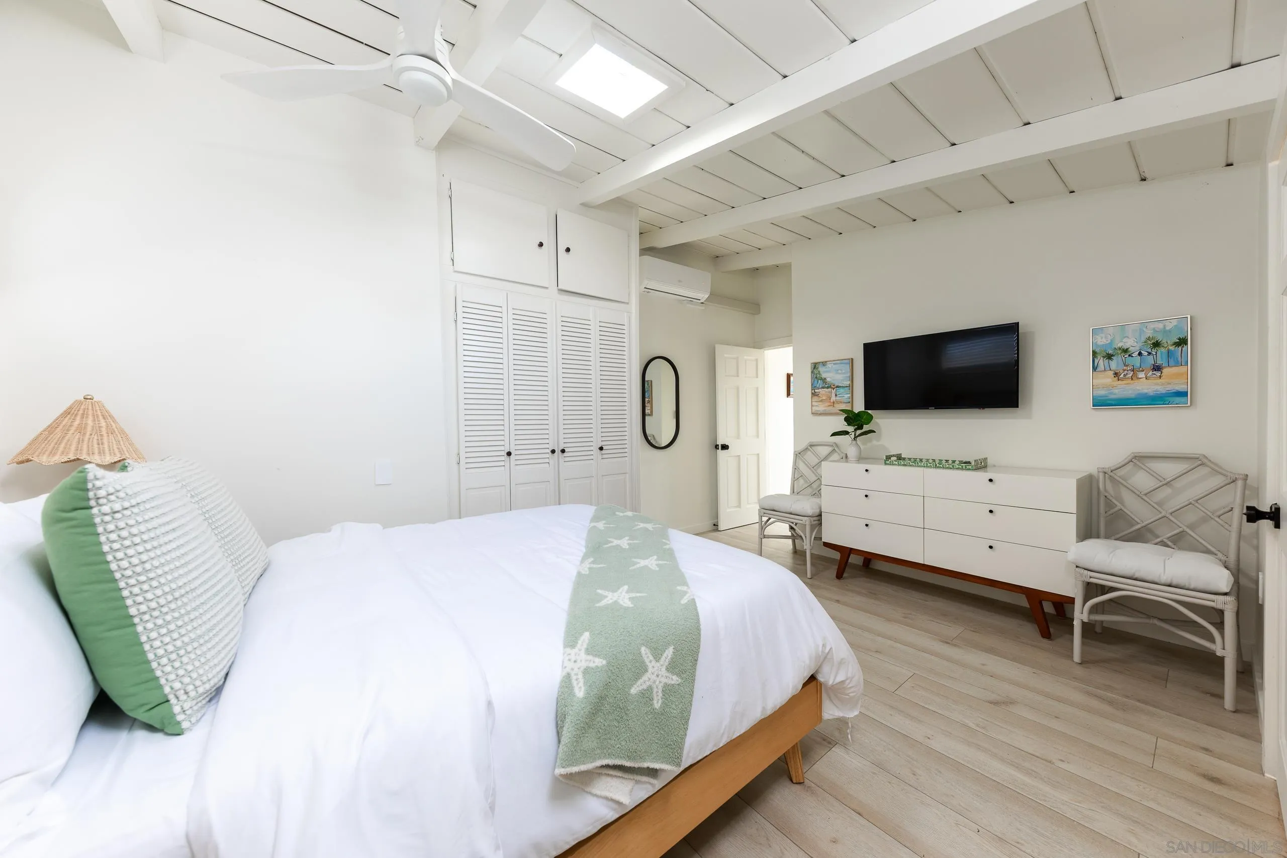 110 8th Street Del Mar, CA 92014 - Photo 22 of 45 a bedroom with a bed and a flat screen tv