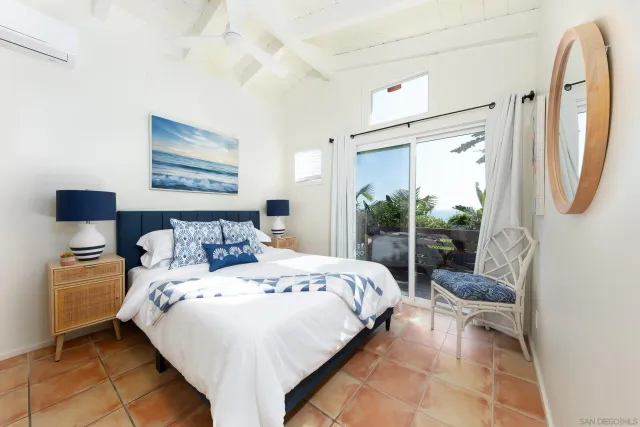 a bathroom with a granite countertop sink a mirror and a bathtub