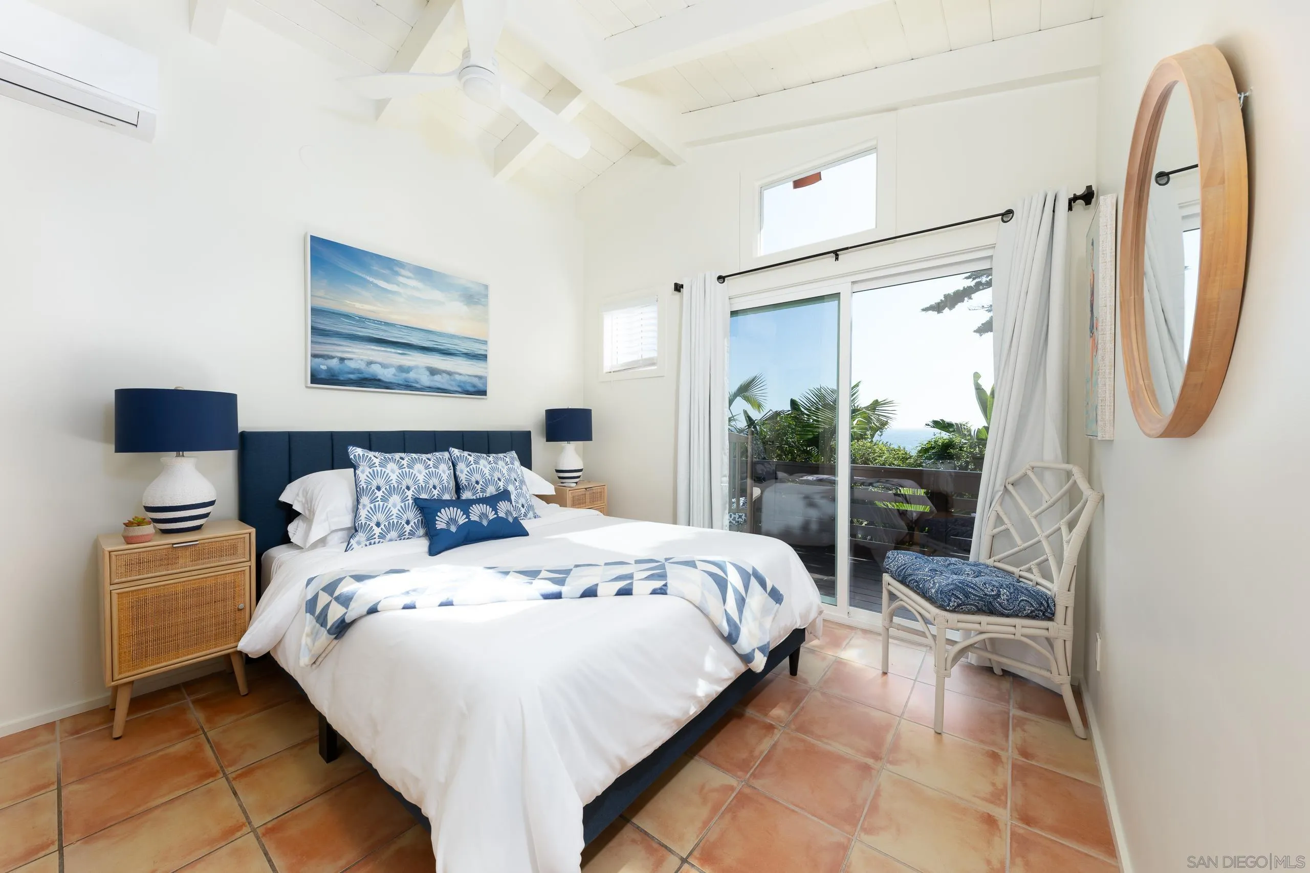 110 8th Street Del Mar, CA 92014 - Photo 33 of 45 a bedroom with a bed a couch and a large mirror on the dresser