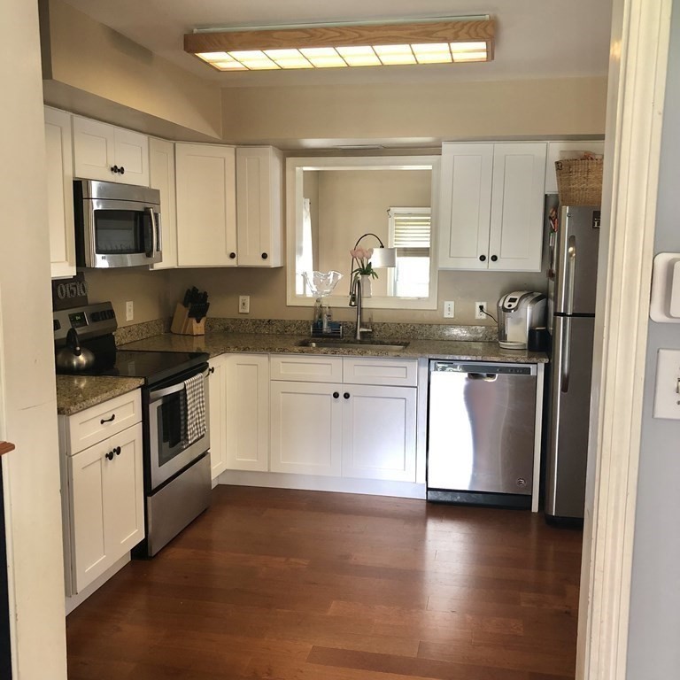 33 Bolton Road Clinton, MA 01510 - Photo 17 of 40 a kitchen with granite countertop white cabinets and white appliances