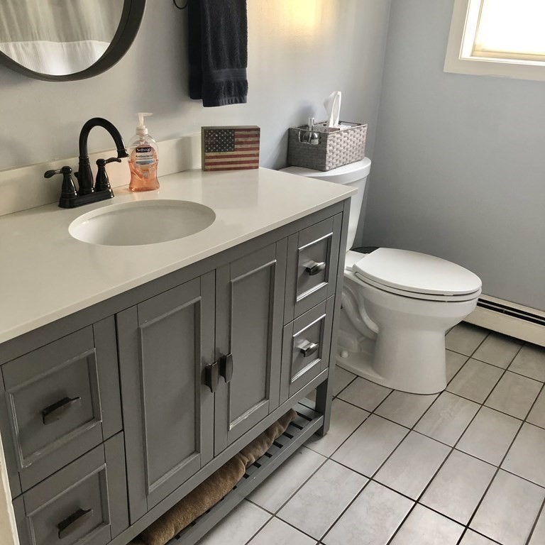 33 Bolton Road Clinton, MA 01510 - Photo 19 of 40 a bathroom with a toilet sink and mirror