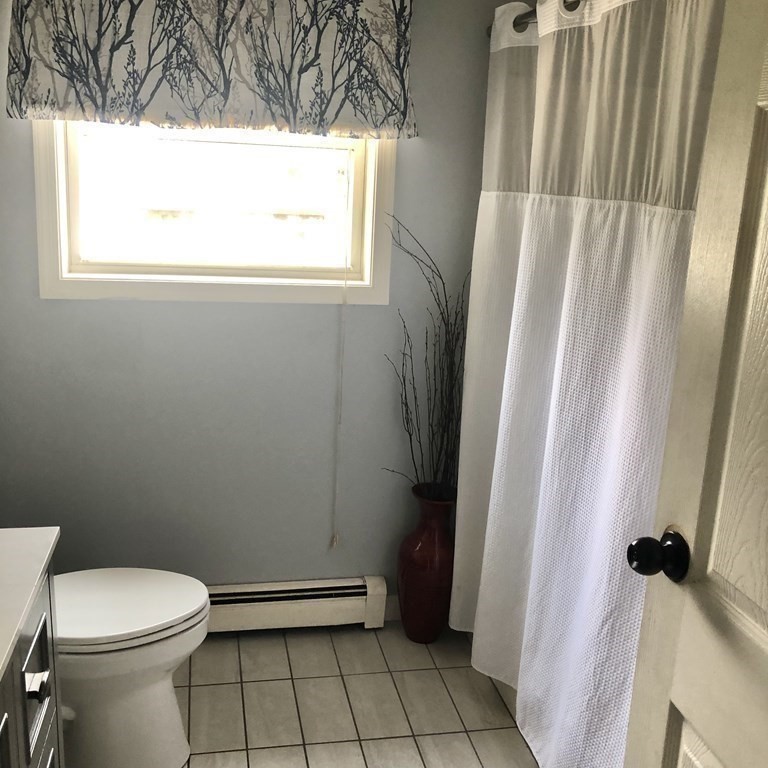 33 Bolton Road Clinton, MA 01510 - Photo 20 of 40 a bathroom with a window a toilet and a shower