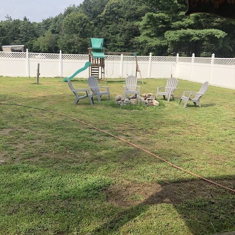 33 Bolton Road Clinton, MA 01510 - Photo 35 of 40 a view of a swimming pool with a lawn chairs under an umbrella