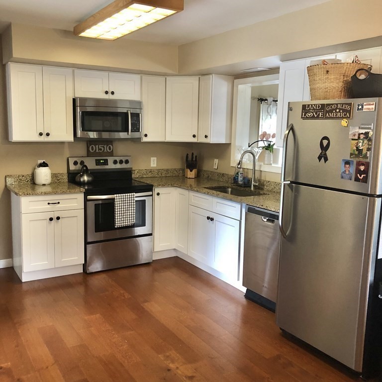 33 Bolton Road Clinton, MA 01510 - Photo 7 of 40 a kitchen with stainless steel appliances and white cabinets