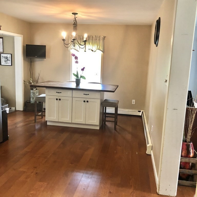 33 Bolton Road Clinton, MA 01510 - Photo 8 of 40 a view of a hallway with front door and wooden floor