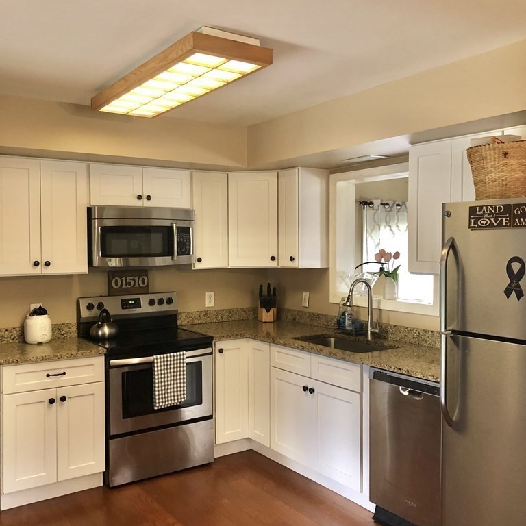 33 Bolton Road Clinton, MA 01510 - Photo 9 of 40 a kitchen with a sink a stove and refrigerator
