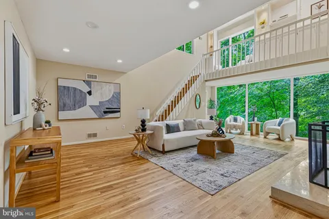 a room with pool table and large windows