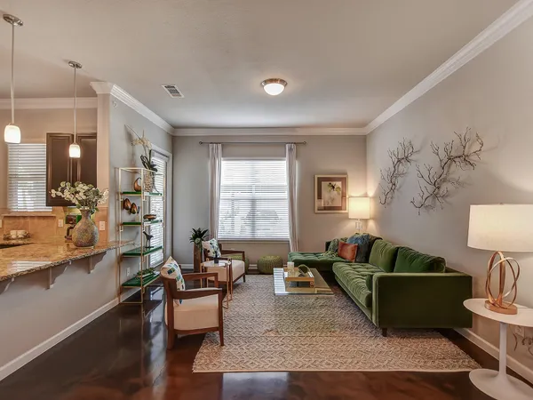 a living room with furniture and wooden floor