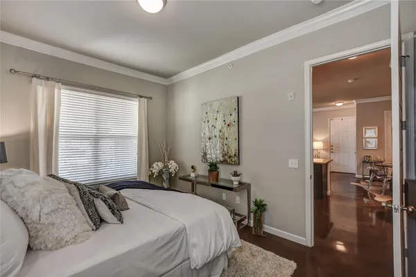 a bedroom with a bed and a large window