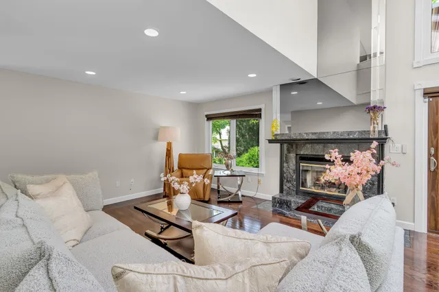a living room with furniture a fireplace and a table