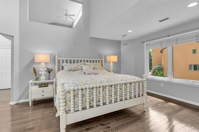 a bedroom with a bed and a large window