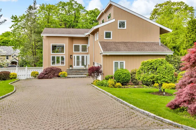 a front view of house with yard and green space