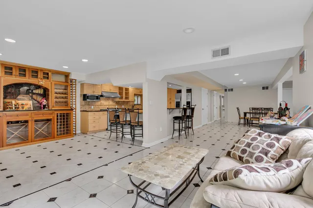 a living room with furniture and kitchen view