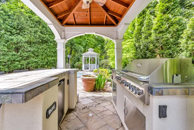 a view of a patio with table and chairs potted plants