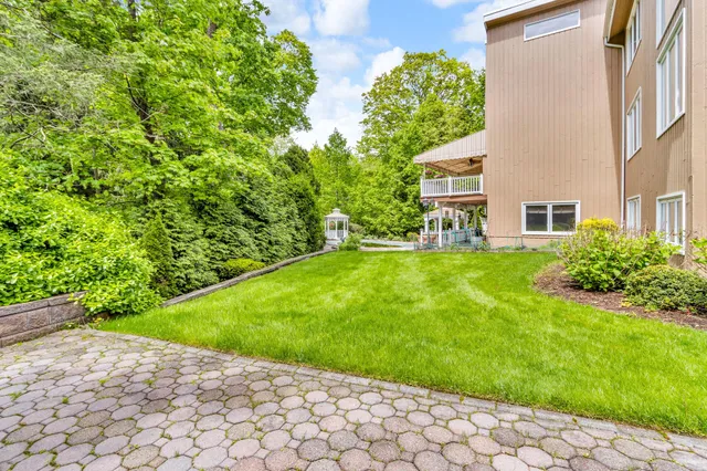 a view of backyard of house with green space
