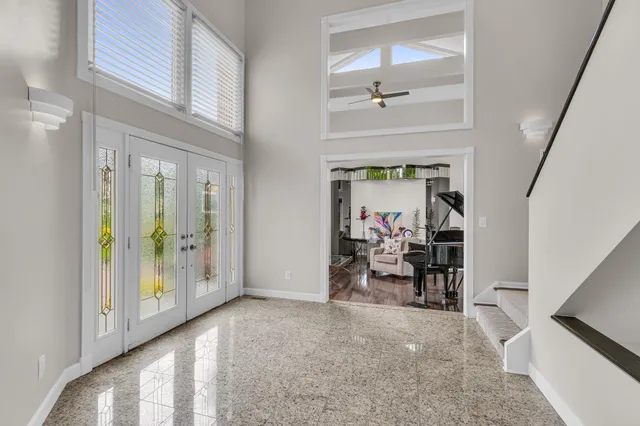 a view of a hallway with dining area and chandelier