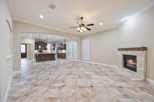 a view of an empty room and fire place