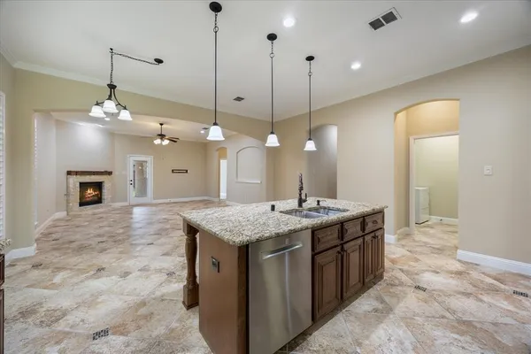 a view of a kitchen counter space a sink and a chandelier